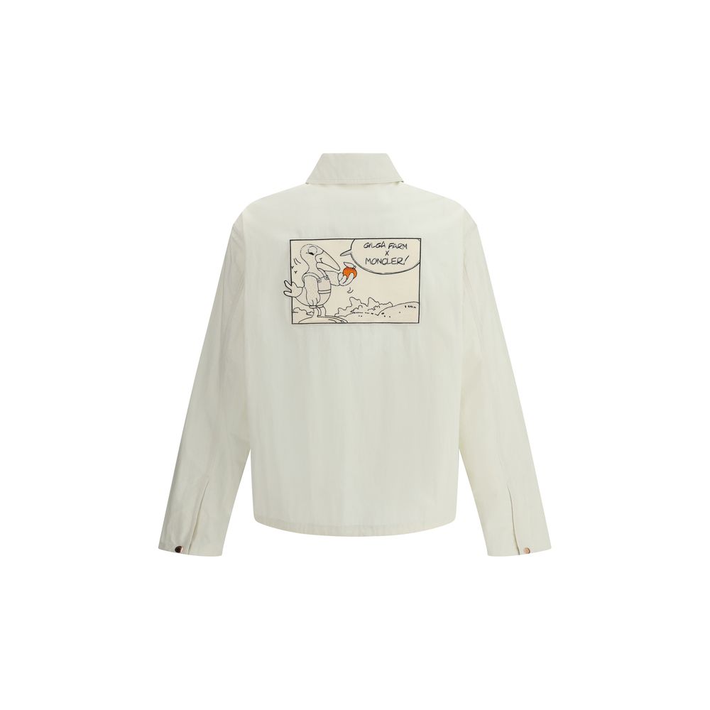 White Cotton CoatThe Moncler x Gilga Farm Satsuma Shirt Jacket by Donald Glover fuses workwear style and visual storytelling. Crafted from durable cotton and nylon canvas, it is part of the Moncler Genius line and stands out for its comic-style patches an