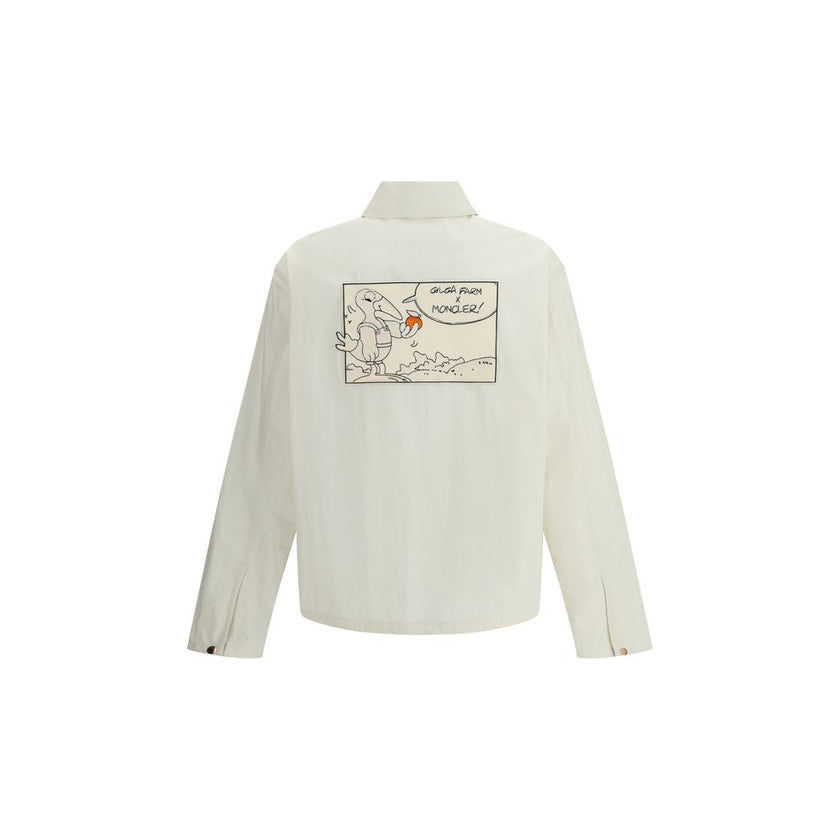 White Cotton CoatThe Moncler x Gilga Farm Satsuma Shirt Jacket by Donald Glover fuses workwear style and visual storytelling. Crafted from durable cotton and nylon canvas, it is part of the Moncler Genius line and stands out for its comic-style patches an