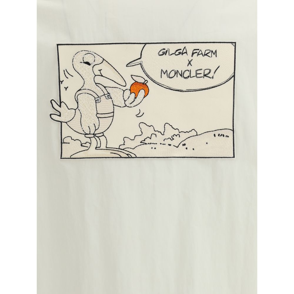 White Cotton CoatThe Moncler x Gilga Farm Satsuma Shirt Jacket by Donald Glover fuses workwear style and visual storytelling. Crafted from durable cotton and nylon canvas, it is part of the Moncler Genius line and stands out for its comic-style patches an