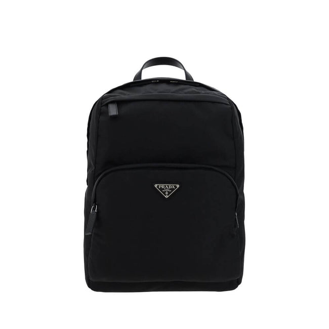 Black Nylon BackpackRe-Nylon backpack by Prada, handle on leather top, adjustable shoulder straps, padded mesh back, zippered top closure, interior slit pocket with zipper closure, interior patch pocket, two exterior zippered pockets, contrasting iconic m
