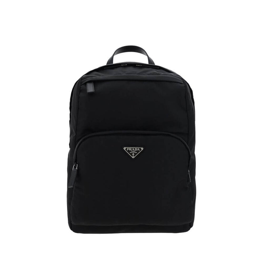 Black Nylon BackpackRe-Nylon backpack by Prada, handle on leather top, adjustable shoulder straps, padded mesh back, zippered top closure, interior slit pocket with zipper closure, interior patch pocket, two exterior zippered pockets, contrasting iconic m