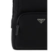 Black Nylon BackpackRe-Nylon backpack by Prada, handle on leather top, adjustable shoulder straps, padded mesh back, zippered top closure, interior slit pocket with zipper closure, interior patch pocket, two exterior zippered pockets, contrasting iconic m
