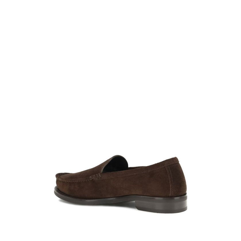 Brown Calf Leather Bos Taurus Slip-On LoafersPrada’s Suede Loafers reinterpret the classic model with a tapered, lightweight silhouette, enhanced by the refined finish of suede leather. The upper is embellished with the screen-printed logo, while the rubb