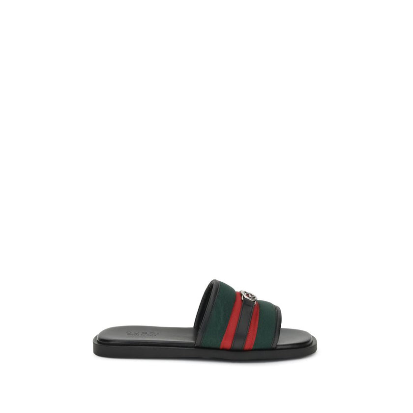 GG motif Slider SandalsGucci’s slider Sandals combine comfort and iconic style. Made of green and red nylon, they feature silver metal details and the unmistakable crisscross GG motif. Complemented by a rubber sole, they stand out for their low profile an