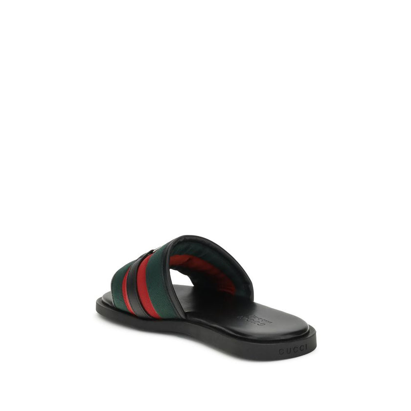 GG motif Slider SandalsGucci’s slider Sandals combine comfort and iconic style. Made of green and red nylon, they feature silver metal details and the unmistakable crisscross GG motif. Complemented by a rubber sole, they stand out for their low profile an