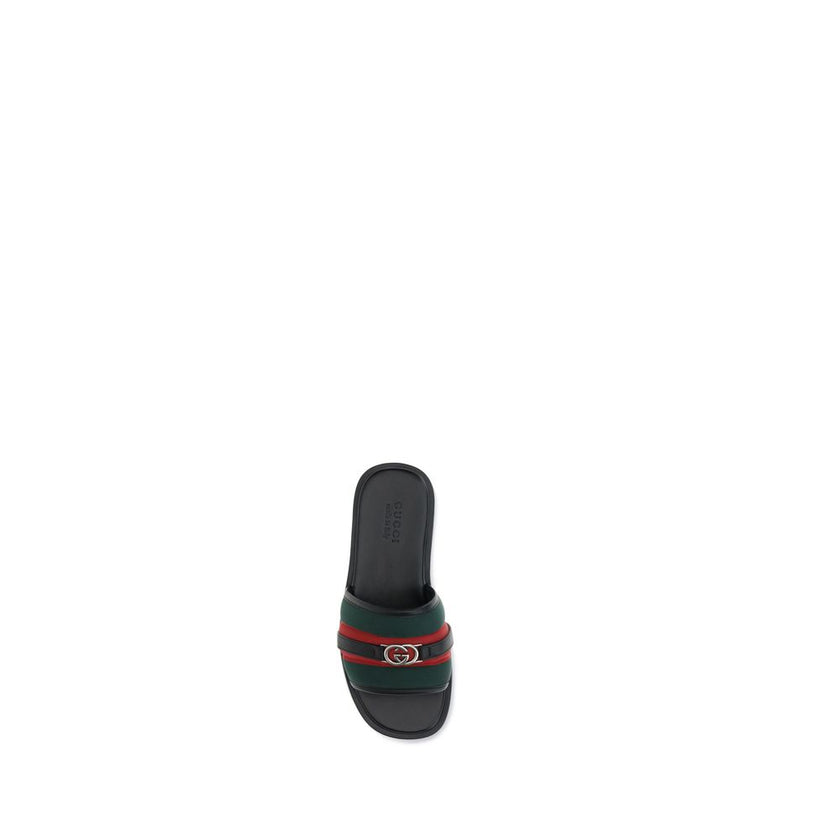GG motif Slider SandalsGucci’s slider Sandals combine comfort and iconic style. Made of green and red nylon, they feature silver metal details and the unmistakable crisscross GG motif. Complemented by a rubber sole, they stand out for their low profile an