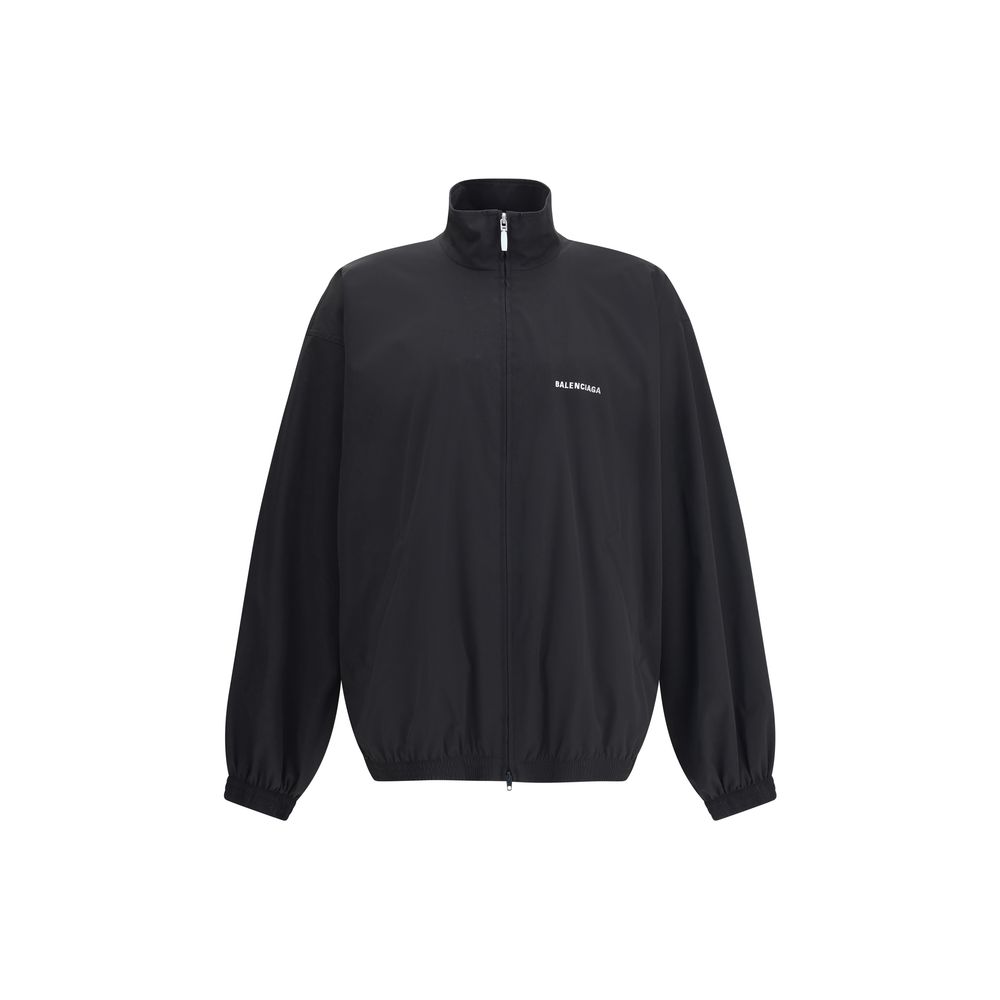 Black Polyester Shell JacketBalenciaga’s Oversized Windbreaker Jacket is a garment with a bold, sporty aesthetic made from durable technical fabric. Featuring contrasting Balenciaga embroidery on the chest and back, it has a high collar, concealed front z