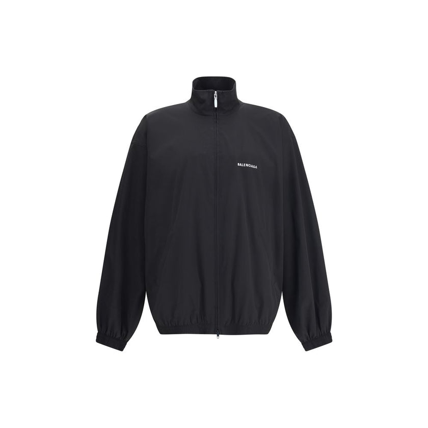 Black Polyester Shell JacketBalenciaga’s Oversized Windbreaker Jacket is a garment with a bold, sporty aesthetic made from durable technical fabric. Featuring contrasting Balenciaga embroidery on the chest and back, it has a high collar, concealed front z