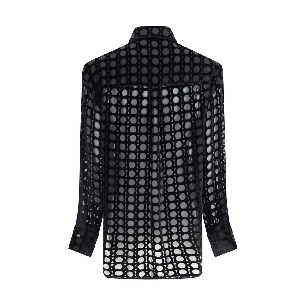 Black Silk Pattern ShirtFerragamo’s velvet devoré Shirt plays with sophisticated transparencies and a Gancini pattern that recalls the brand’s heritage. Its essential construction, characterized by an asymmetrical, rounded bottom, makes it perfect for ele
