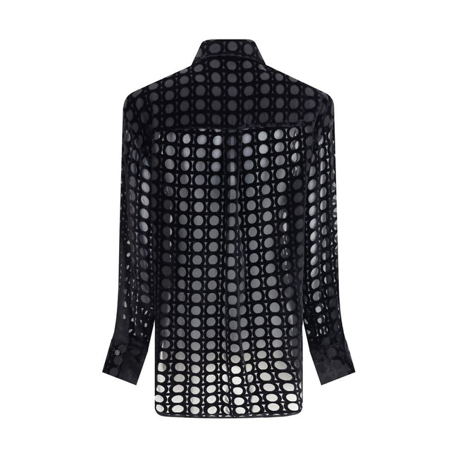 Black Silk Pattern ShirtFerragamo’s velvet devoré Shirt plays with sophisticated transparencies and a Gancini pattern that recalls the brand’s heritage. Its essential construction, characterized by an asymmetrical, rounded bottom, makes it perfect for ele