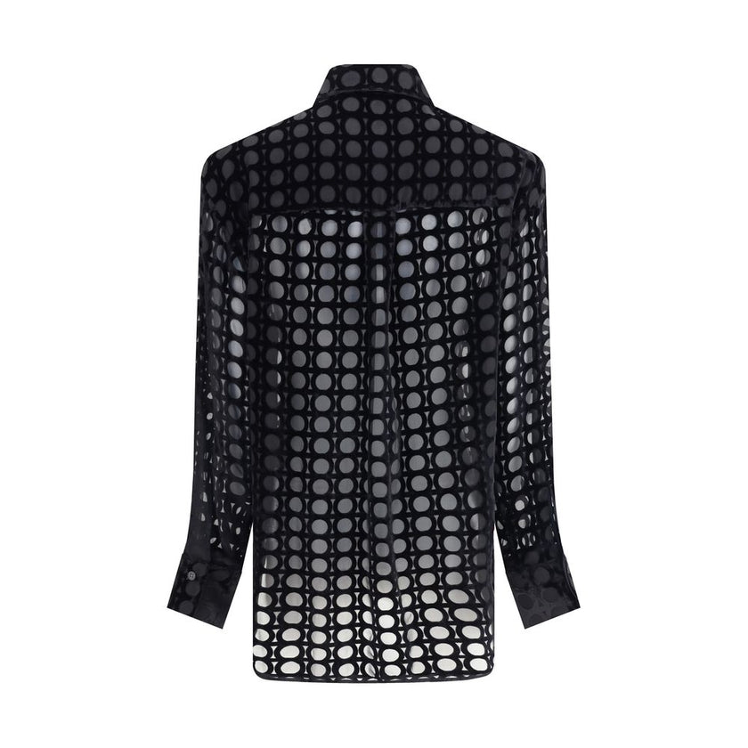Black Silk Pattern ShirtFerragamo’s velvet devoré Shirt plays with sophisticated transparencies and a Gancini pattern that recalls the brand’s heritage. Its essential construction, characterized by an asymmetrical, rounded bottom, makes it perfect for ele