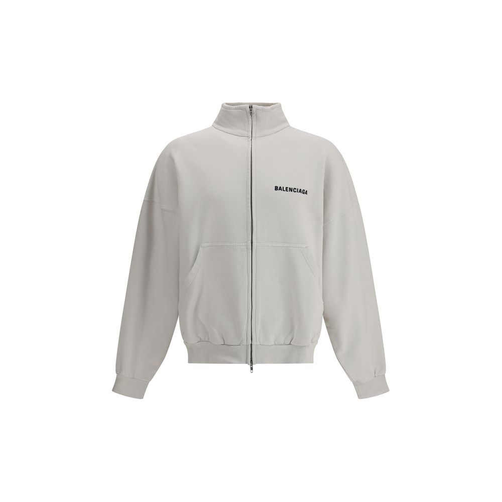 White Cotton SweatshirtBalenciaga’s Logo Sweatshirt stands out for its worn effect, which gives the garment a worn and contemporary character. On the front it features two patch pockets, practical and with a casual look, while the hem and cuffs are finish