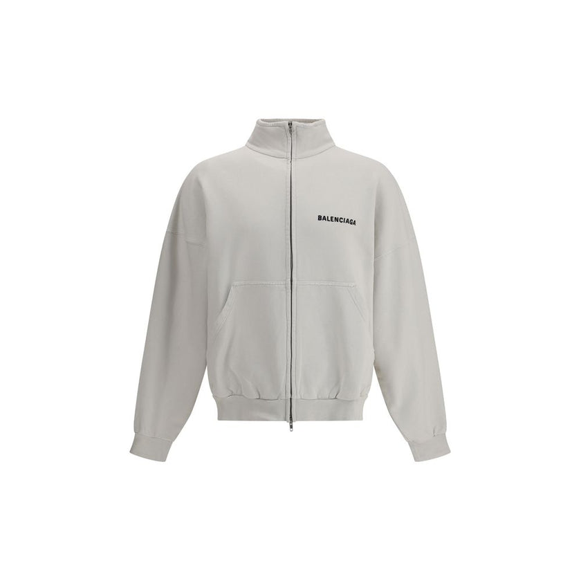 White Cotton SweatshirtBalenciaga’s Logo Sweatshirt stands out for its worn effect, which gives the garment a worn and contemporary character. On the front it features two patch pockets, practical and with a casual look, while the hem and cuffs are finish