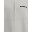 White Cotton SweatshirtBalenciaga’s Logo Sweatshirt stands out for its worn effect, which gives the garment a worn and contemporary character. On the front it features two patch pockets, practical and with a casual look, while the hem and cuffs are finish