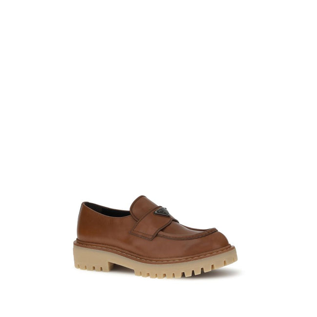 Brown Calf Leather Bos Taurus Slip-On LoafersPrada’s leather Loafers combine elegance and boldness with their patent-effect leather design, giving them a polished and sophisticated look. The rugged and durable carrarmate sole adds a touch of modernity and