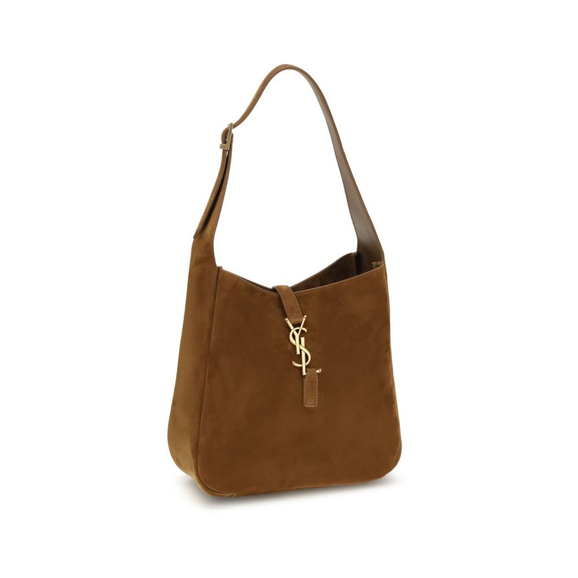 Brown Calf Leather Bos Taurus Shoulder BagThe Le 5 à 7 Shoulder Bag by Saint Laurent, made of suede leather, is an elegant accessory that combines sophistication and practicality. The adjustable flat handle, located at the top, allows it to be carried com