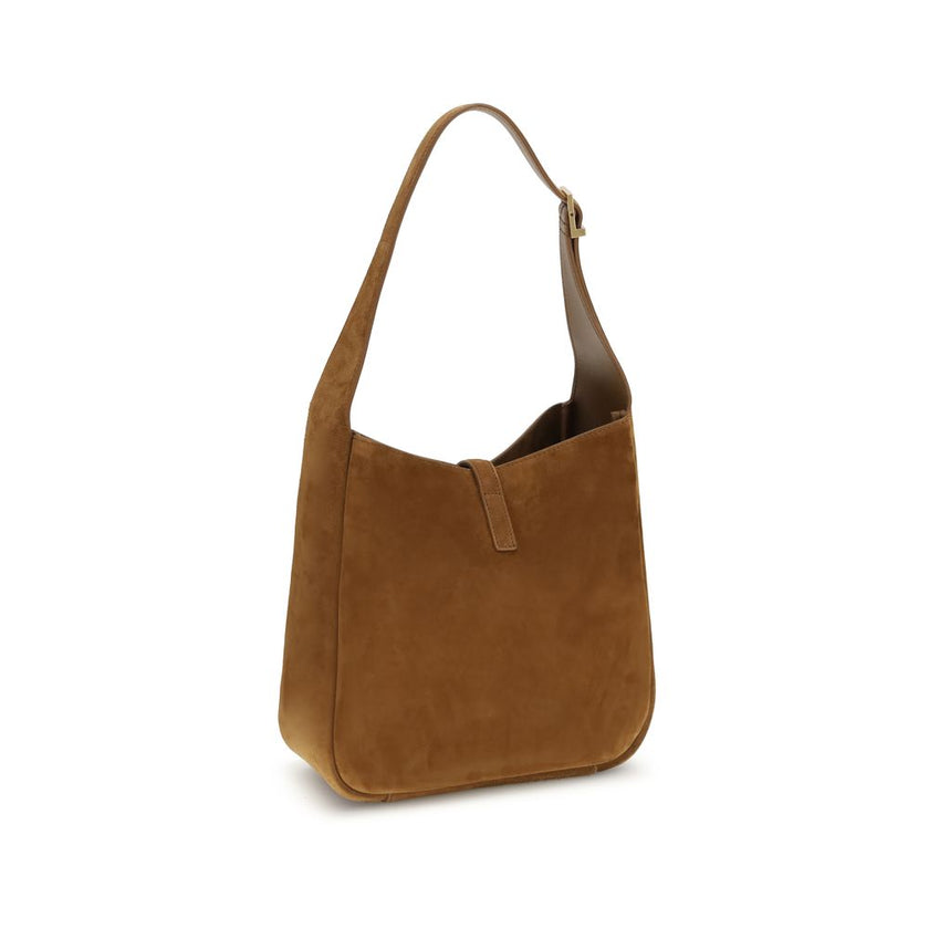Brown Calf Leather Bos Taurus Shoulder BagThe Le 5 à 7 Shoulder Bag by Saint Laurent, made of suede leather, is an elegant accessory that combines sophistication and practicality. The adjustable flat handle, located at the top, allows it to be carried com