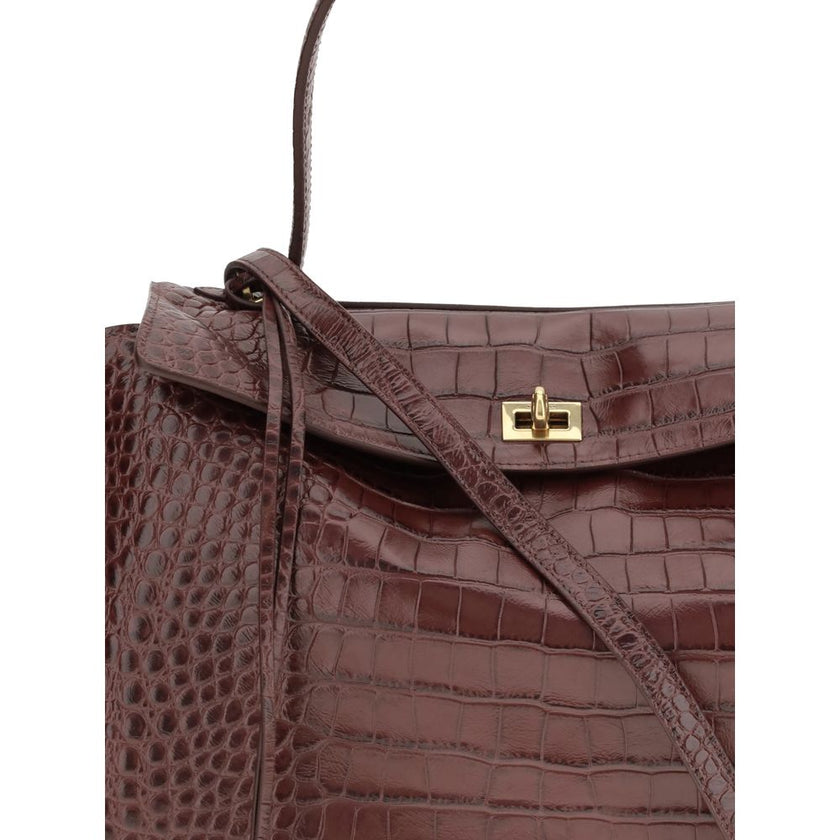 Brown Calf Leather Bos Taurus HandbagLeather Medium Rodeo Handbag by Balenciaga, single removable top handle, charm with key ring detail applied at base of handle, dual compartment, flap closure with swivel system at front, crocodile-effect leather design