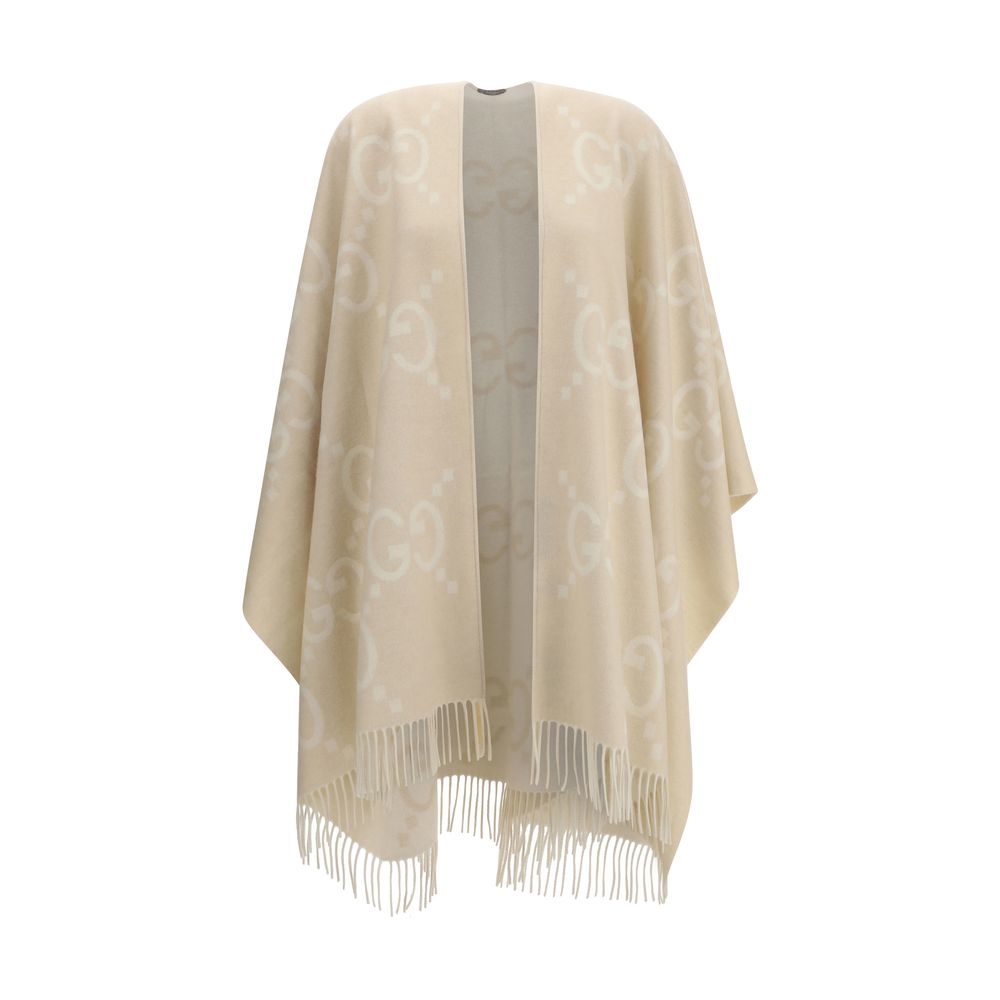 Beige Cashmere CoatCashmere Cape by Gucci, reversible cape design, shawl lapels, frayed hem, iconic all-over contrasting brand logo, oversized fit. Season: AW25 Fit: Regular Composition: 100% Kashmir/capra Hircus MADE IN ITALYBeige Cashmere Coat${tagsGucc