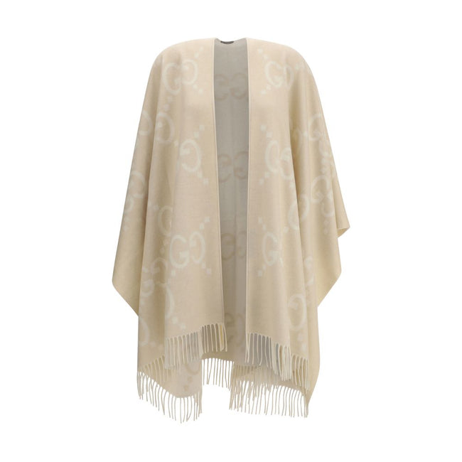 Beige Cashmere CoatCashmere Cape by Gucci, reversible cape design, shawl lapels, frayed hem, iconic all-over contrasting brand logo, oversized fit. Season: AW25 Fit: Regular Composition: 100% Kashmir/capra Hircus MADE IN ITALYBeige Cashmere Coat${tagsGucc