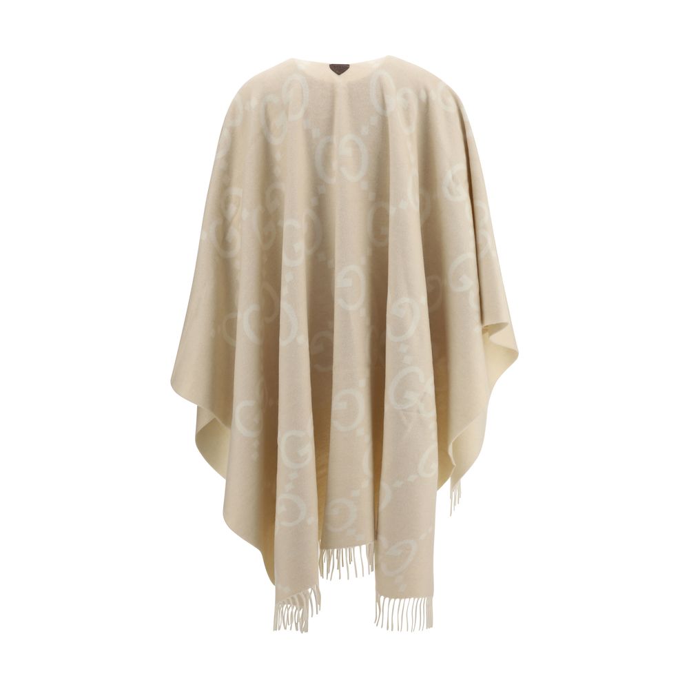 Beige Cashmere CoatCashmere Cape by Gucci, reversible cape design, shawl lapels, frayed hem, iconic all-over contrasting brand logo, oversized fit. Season: AW25 Fit: Regular Composition: 100% Kashmir/capra Hircus MADE IN ITALYBeige Cashmere Coat${tagsGucc