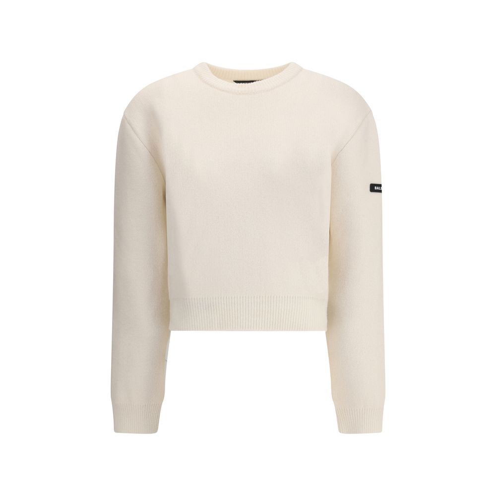 White Wool SweatshirtBalenciaga’s virgin wool Sweater is an essential piece that combines comfort and contemporary style. Made from fine virgin wool, it offers a soft and warm feel against the skin. The design includes a classic crew neck, dropped shoulde
