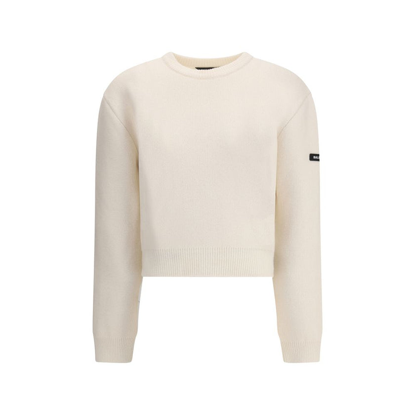 White Wool SweatshirtBalenciaga’s virgin wool Sweater is an essential piece that combines comfort and contemporary style. Made from fine virgin wool, it offers a soft and warm feel against the skin. The design includes a classic crew neck, dropped shoulde