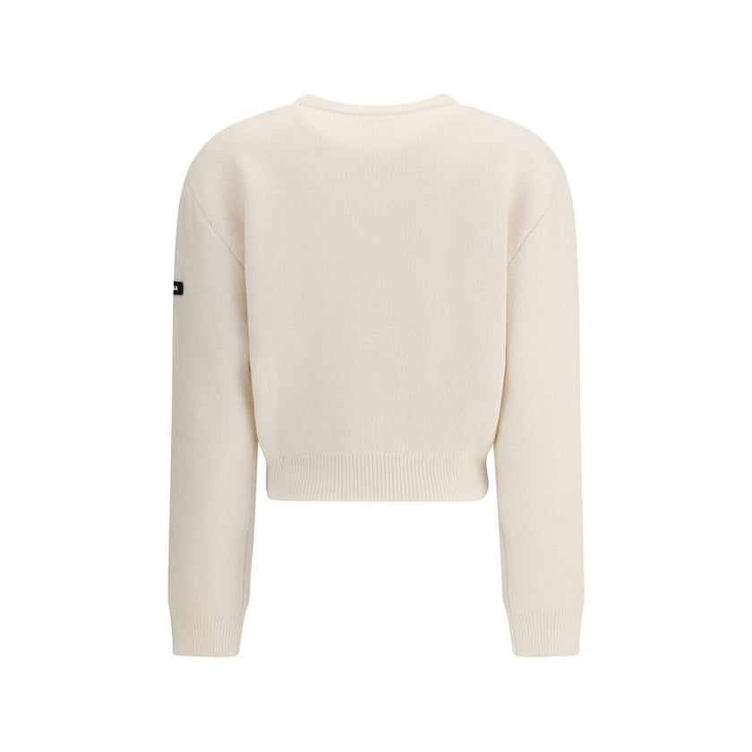 White Wool SweatshirtBalenciaga’s virgin wool Sweater is an essential piece that combines comfort and contemporary style. Made from fine virgin wool, it offers a soft and warm feel against the skin. The design includes a classic crew neck, dropped shoulde