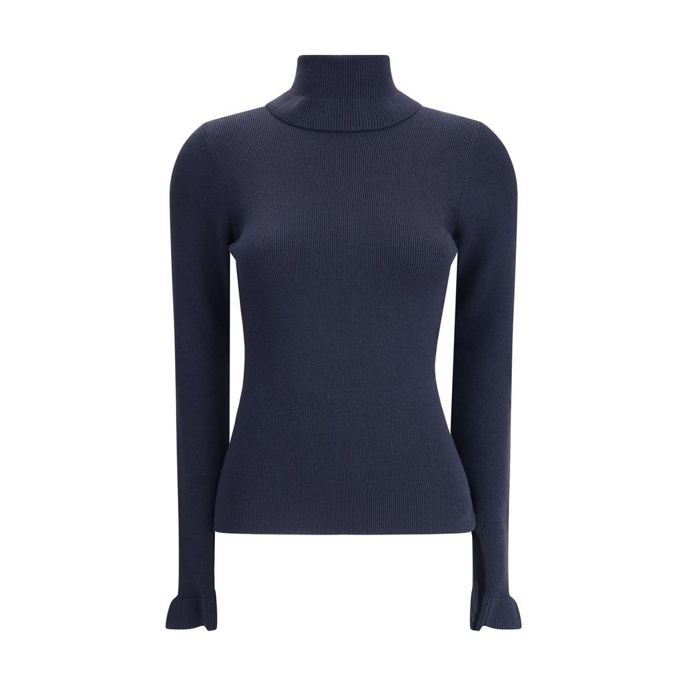 Blue Wool TurtleneckThe Chloé wool and cotton turtleneck Sweater combines elegance and comfort with a romantic touch. The ruffled details on the collar and cuffs add delicacy to the design, while the gold-tone Chloé logo plaque on the back signs the piece