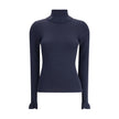 Blue Wool TurtleneckThe Chloé wool and cotton turtleneck Sweater combines elegance and comfort with a romantic touch. The ruffled details on the collar and cuffs add delicacy to the design, while the gold-tone Chloé logo plaque on the back signs the piece