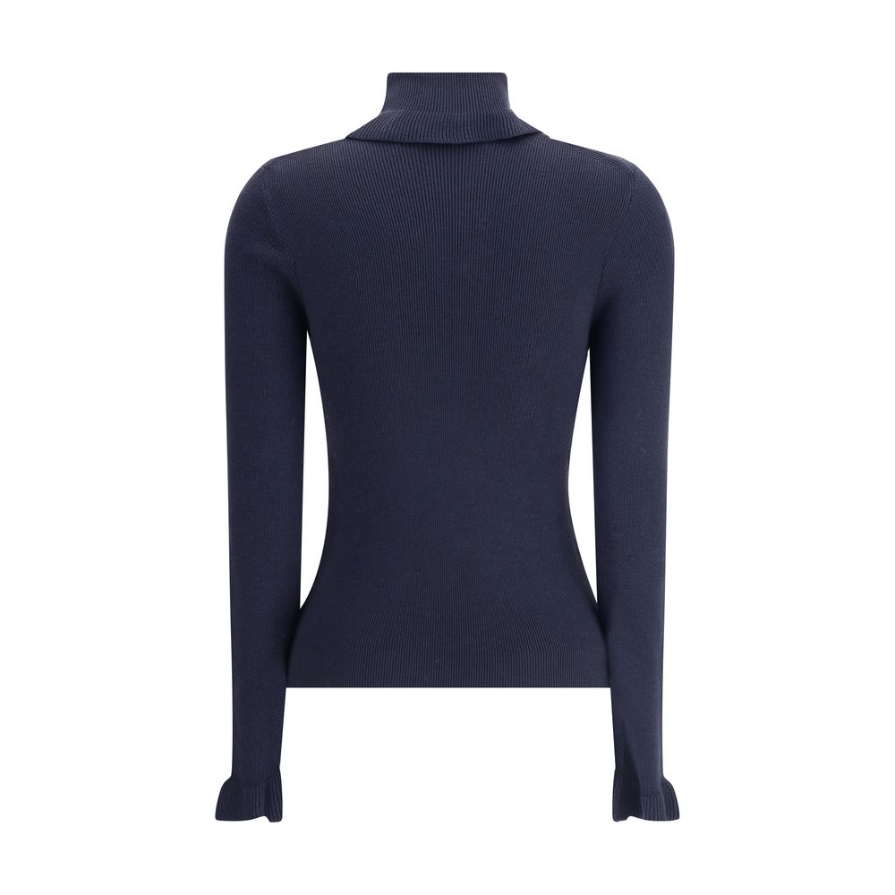 Blue Wool TurtleneckThe Chloé wool and cotton turtleneck Sweater combines elegance and comfort with a romantic touch. The ruffled details on the collar and cuffs add delicacy to the design, while the gold-tone Chloé logo plaque on the back signs the piece
