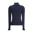Blue Wool TurtleneckThe Chloé wool and cotton turtleneck Sweater combines elegance and comfort with a romantic touch. The ruffled details on the collar and cuffs add delicacy to the design, while the gold-tone Chloé logo plaque on the back signs the piece