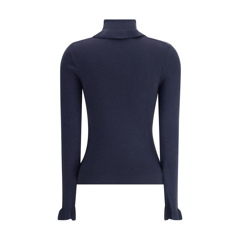 Blue Wool TurtleneckThe Chloé wool and cotton turtleneck Sweater combines elegance and comfort with a romantic touch. The ruffled details on the collar and cuffs add delicacy to the design, while the gold-tone Chloé logo plaque on the back signs the piece
