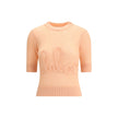 Logo wool SweaterChloé’s Logo wool Sweater is a luxurious piece that combines comfort with recognizable style. It features a classic crew neck and elbow-length sleeves, made from a fine alpaca wool-silk knit that ensures exceptional softness and a smooth