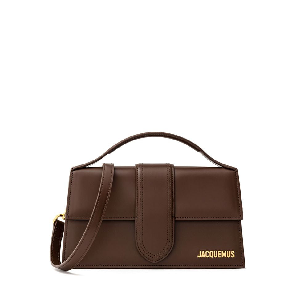 Brown Leather HandbagLe Grand Bambino Brown Leather Bag Jacquemus. Front opening with rigid flap and covered snap button. Single internal pocket, removable shoulder strap, applied back pocket. Composition: 100% Leather Brand Sku: 213BA007- 3100 850Brown L