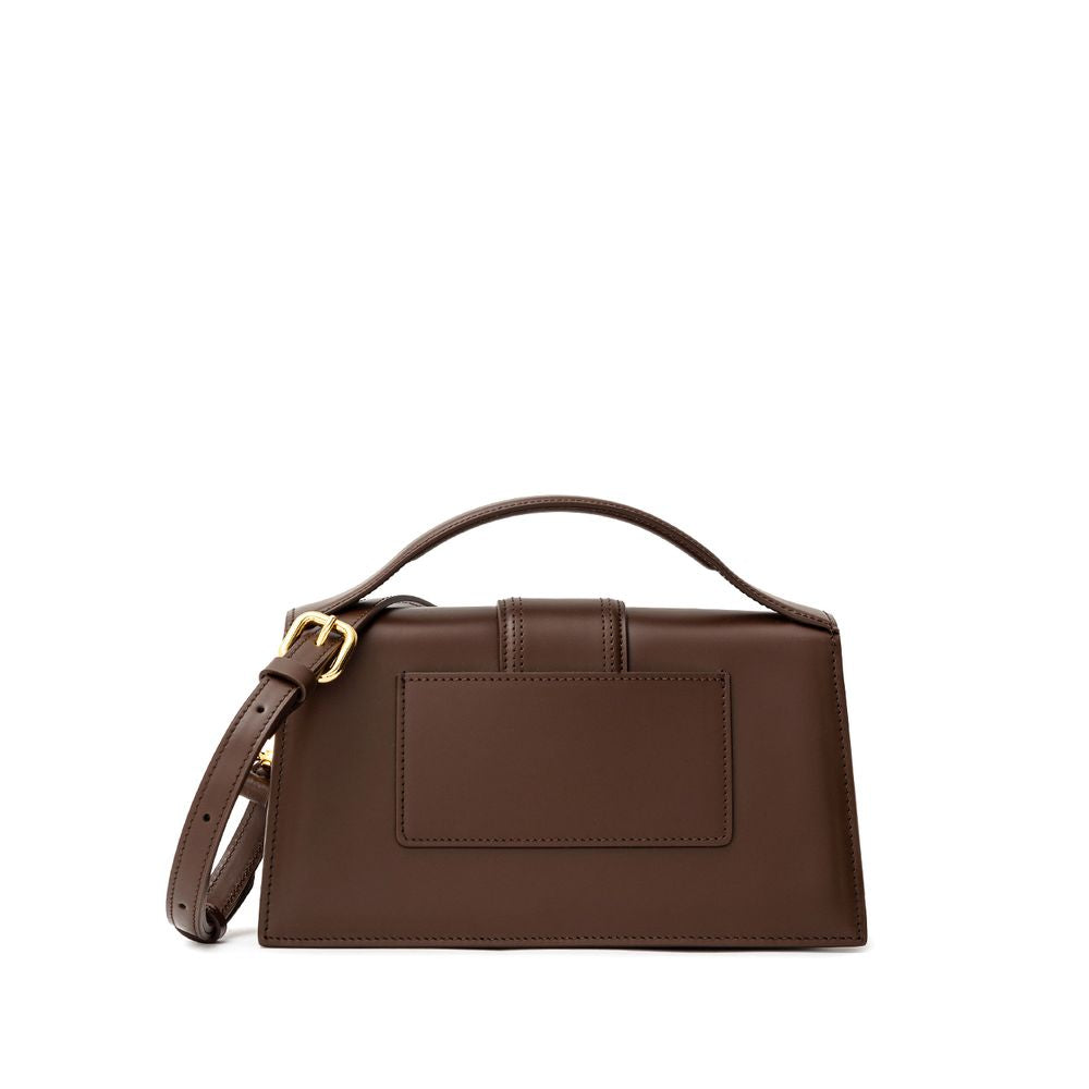 Brown Leather HandbagLe Grand Bambino Brown Leather Bag Jacquemus. Front opening with rigid flap and covered snap button. Single internal pocket, removable shoulder strap, applied back pocket. Composition: 100% Leather Brand Sku: 213BA007- 3100 850Brown L