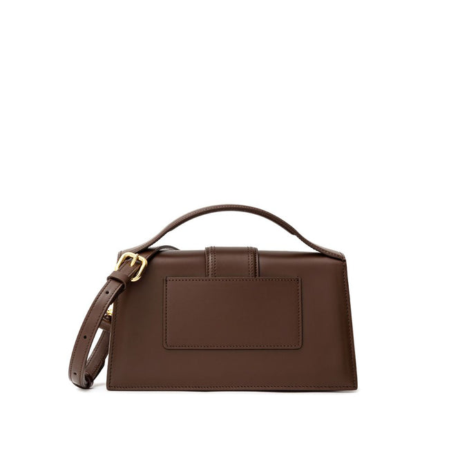 Brown Leather HandbagLe Grand Bambino Brown Leather Bag Jacquemus. Front opening with rigid flap and covered snap button. Single internal pocket, removable shoulder strap, applied back pocket. Composition: 100% Leather Brand Sku: 213BA007- 3100 850Brown L