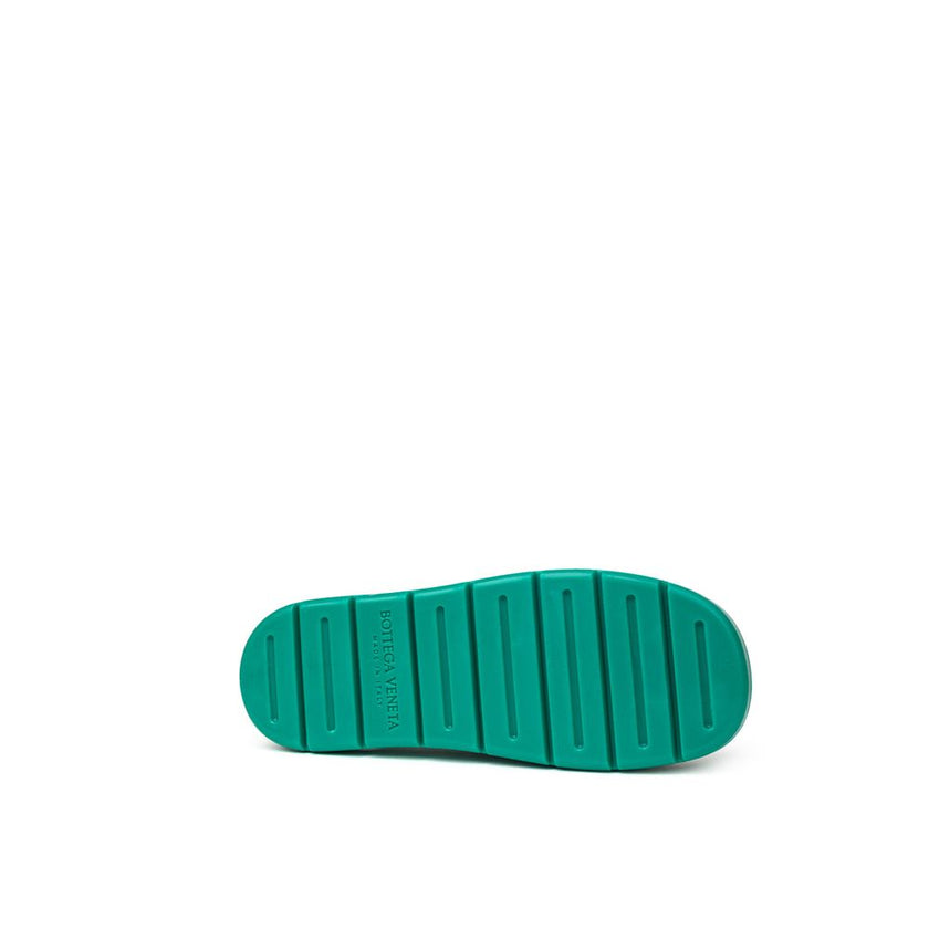 Green Cotton SlippersBottega Veneta Green Matte Rubber Puddle Slippers Sandals. Round toe, closed front and back strap, tone-on-tone engraved logo on the insole Composition: Rubber Internal SKU: 25GIU93 Brand SKU: 661269V00P03227Green Cotton Slippers${tag