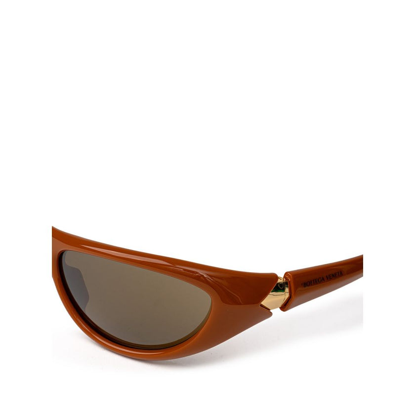 Brown Acetate SunglassesBottega Veneta Brown Acetate Sunglasses. Elongated sporty frame in brown leather, slightly mirrored dark lenses, gold details on the temples, logo embossed on the arm. Composition: Acetate Internal SKU: 25GIU84 Brand SKU: 744692VBL