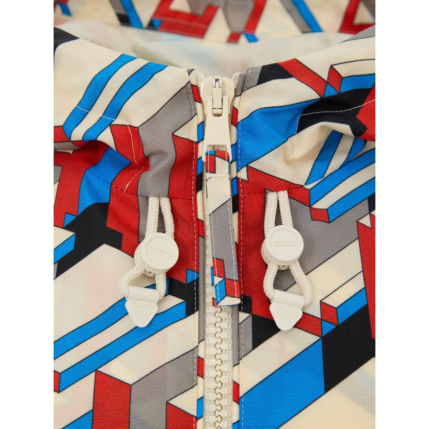 Multicolor Polyamide Shell JacketNylon Jacket with Multicolor Geometric Print Gucci. In red, blue and ivory, front fastening with white zip, two side pockets closed with zip, adjustable hood with pullers, adjustable elastic waist, internal lining Composit