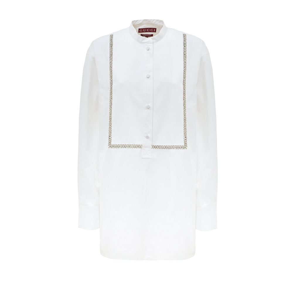 White Cotton BlouseWhite Cotton Poplin Blouse with Gucci Crystal Decorations. Front fastening with tone-on-tone fabric-covered buttons, round neckline, piqué panel, edge with crystal and bead details, rounded at the bottom Composition: 100% Cotton Interna