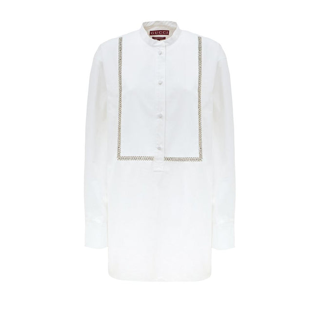 White Cotton BlouseWhite Cotton Poplin Blouse with Gucci Crystal Decorations. Front fastening with tone-on-tone fabric-covered buttons, round neckline, piqué panel, edge with crystal and bead details, rounded at the bottom Composition: 100% Cotton Interna