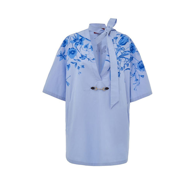 Blue Cotton Pattern ShirtLight Blue Cotton Poplin Kimono Shirt with Gucci Flower Print. Deep V-neckline with bow, iconic metal and leather horsebit applied on the front, two side welt pockets, rounded on the front and squared on the back. Contrasting flow