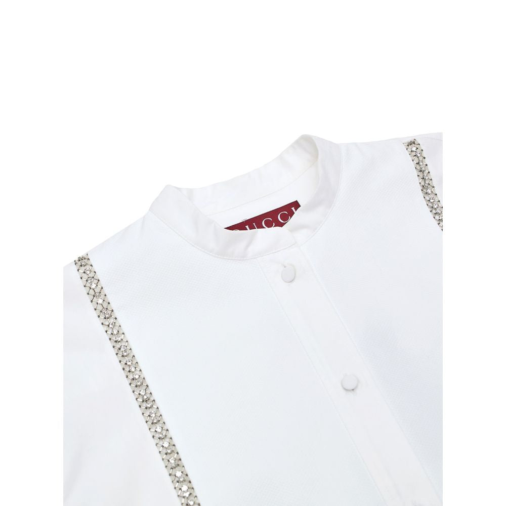 White Cotton BlouseWhite Cotton Poplin Blouse with Gucci Crystal Decorations. Front fastening with tone-on-tone fabric-covered buttons, round neckline, piqué panel, edge with crystal and bead details, rounded at the bottom Composition: 100% Cotton Interna