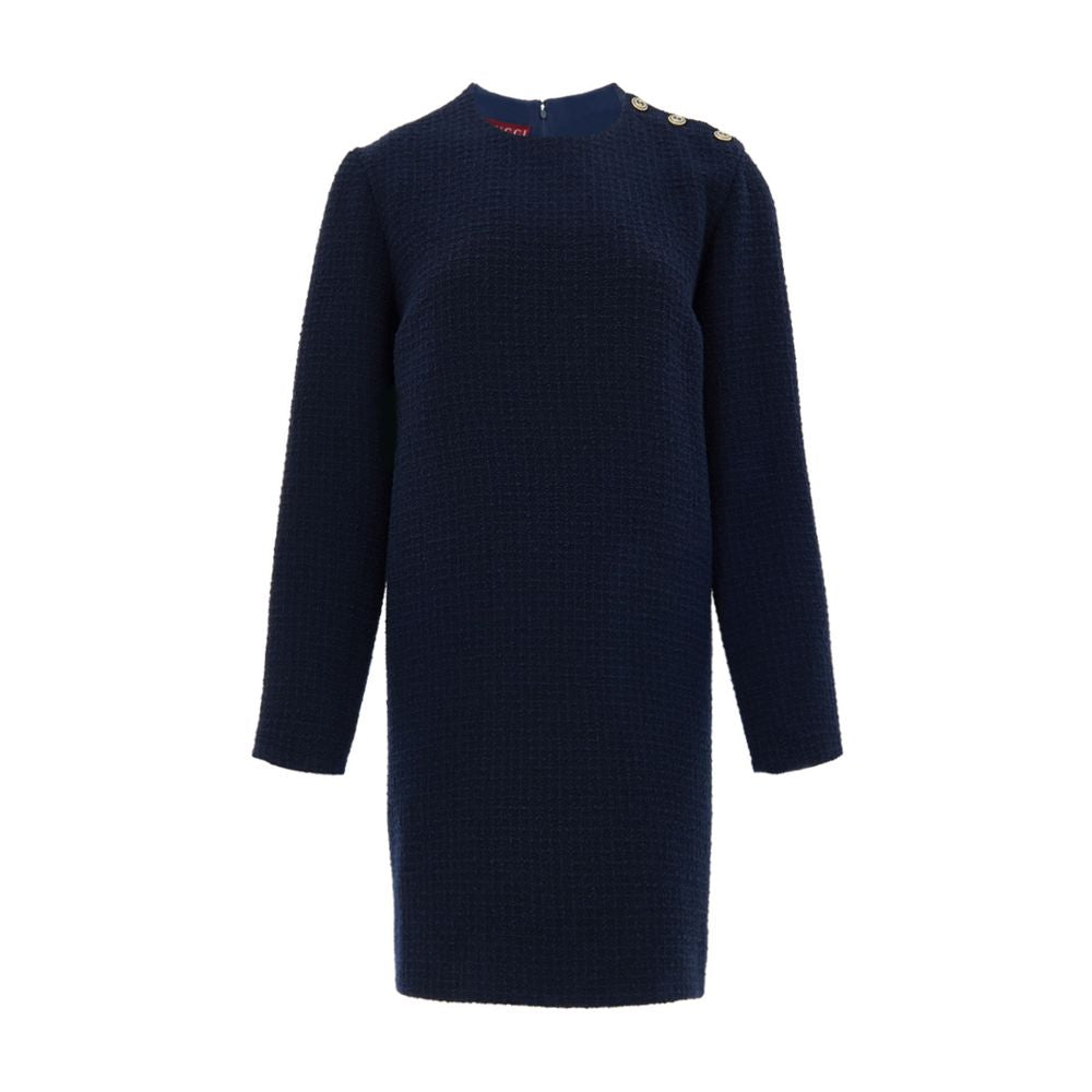 Navy Blue Wool Short DressBlue Bouclé Dress with Gucci Logo Buttons. Mid-length dress, round neckline, long sleeves, two side welt pockets, opening on the shoulder with gold Gucci logo buttons. Straight tube line, internal lining Composition: 84% Wool 16%
