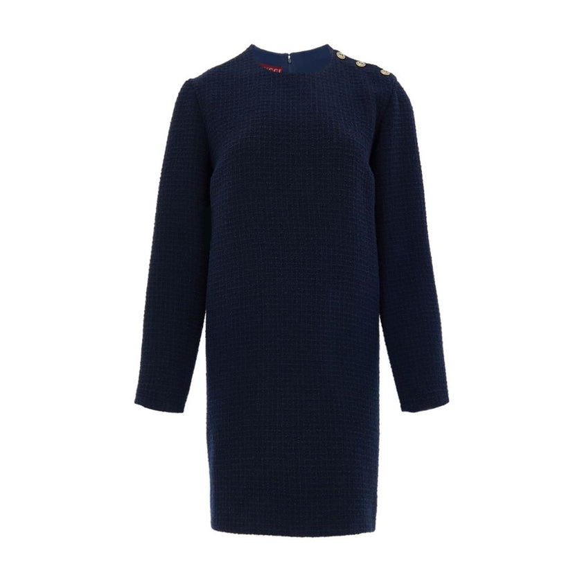 Navy Blue Wool Short DressBlue Bouclé Dress with Gucci Logo Buttons. Mid-length dress, round neckline, long sleeves, two side welt pockets, opening on the shoulder with gold Gucci logo buttons. Straight tube line, internal lining Composition: 84% Wool 16%