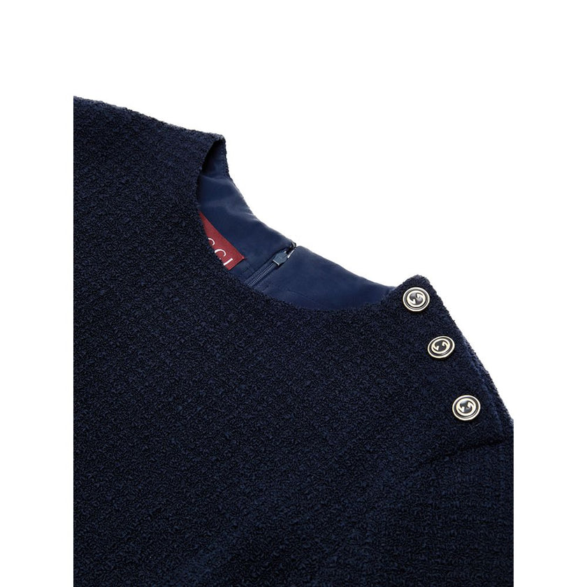 Navy Blue Wool Short DressBlue Bouclé Dress with Gucci Logo Buttons. Mid-length dress, round neckline, long sleeves, two side welt pockets, opening on the shoulder with gold Gucci logo buttons. Straight tube line, internal lining Composition: 84% Wool 16%