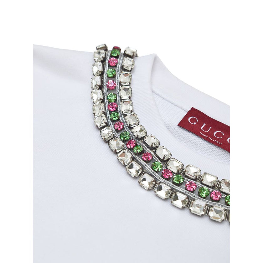 White Cotton SweatshirtWhite Sweatshirt with Jewel Neck Gucci. Round neckline, long sleeves, opening on the shoulder with hidden zip. Jewel neck detail with crystals applied as a necklace Composition: 100% Cotton Internal SKU: 25GIU208 Brand SKU: 791337XJ