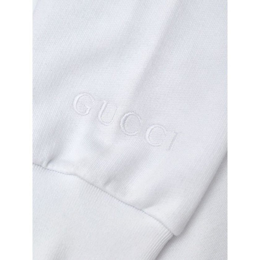White Cotton SweatshirtWhite Sweatshirt with Jewel Neck Gucci. Round neckline, long sleeves, opening on the shoulder with hidden zip. Jewel neck detail with crystals applied as a necklace Composition: 100% Cotton Internal SKU: 25GIU208 Brand SKU: 791337XJ