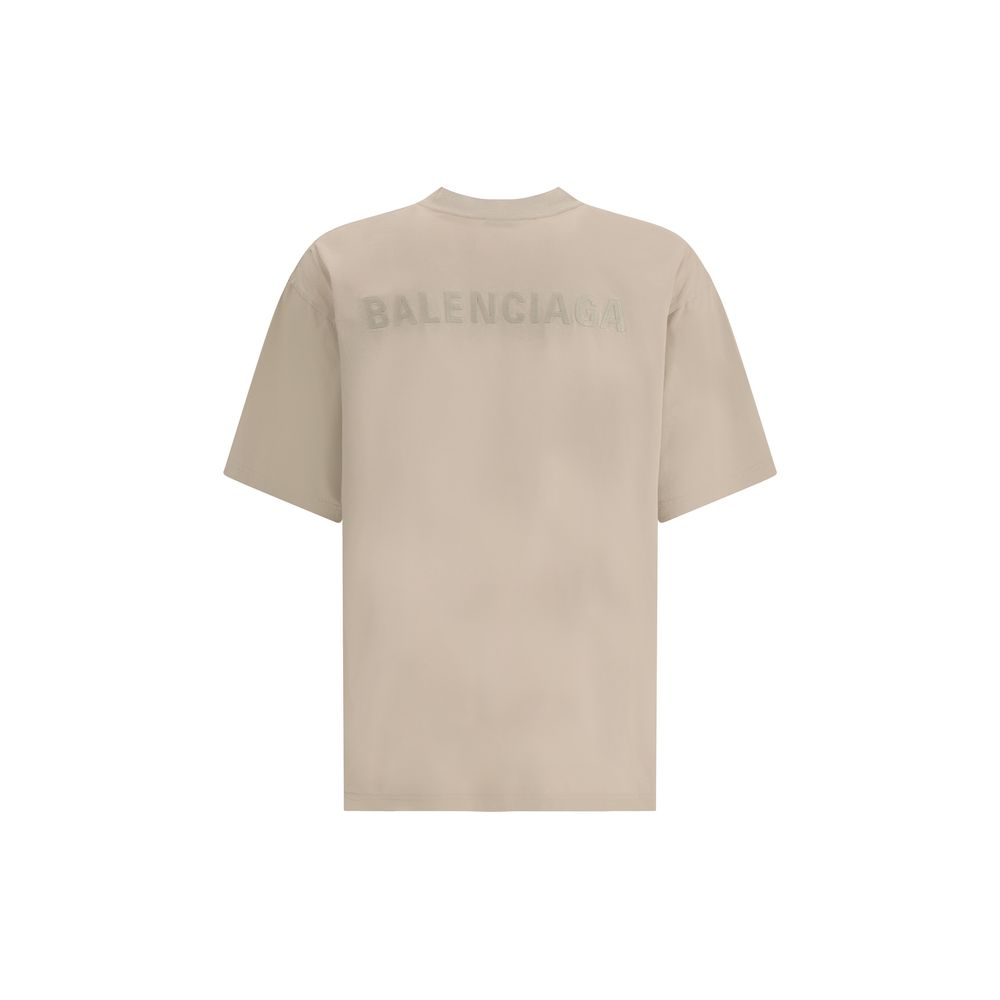 Logoed T-ShirtBalenciaga’s Logo T-Shirt features a ribbed crew neck with a distressed effect, adding a worn-in touch to the design. The iconic tone-on-tone stitched logo on the front completes the garment with understated elegance. Season: AW25 Fit: Overs